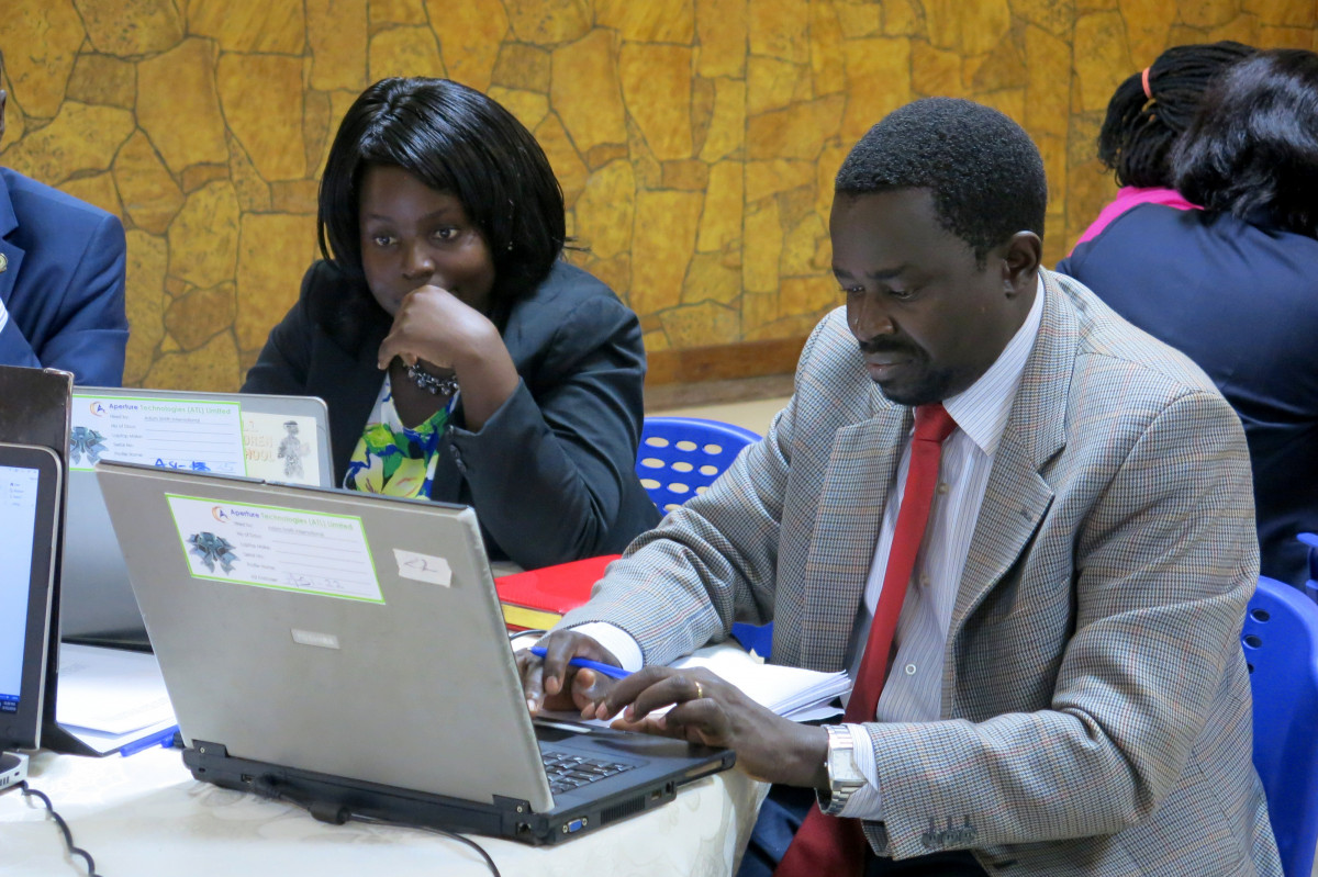 Ugandan man and woman looking at a computer