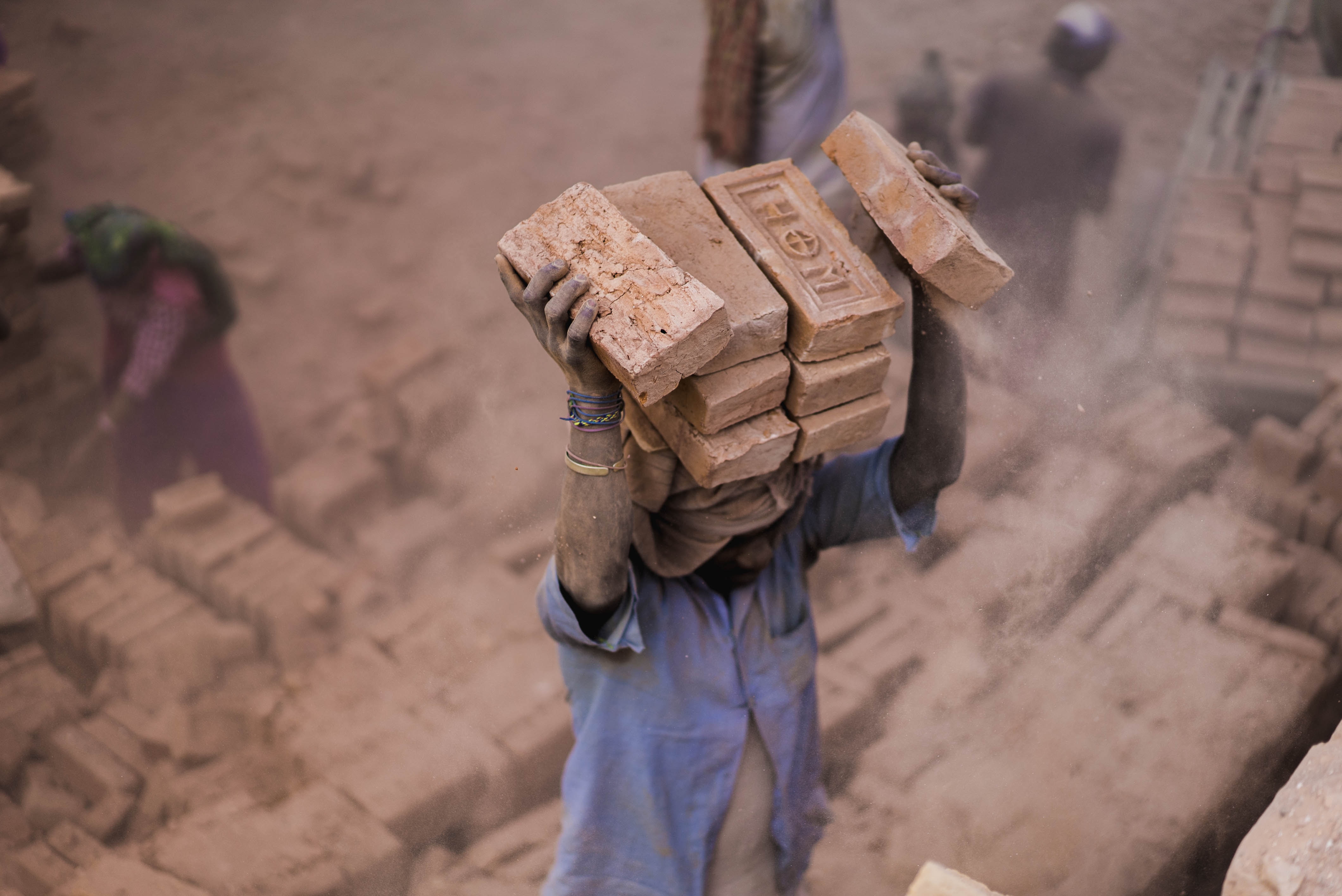 Man carrying bricks on his head