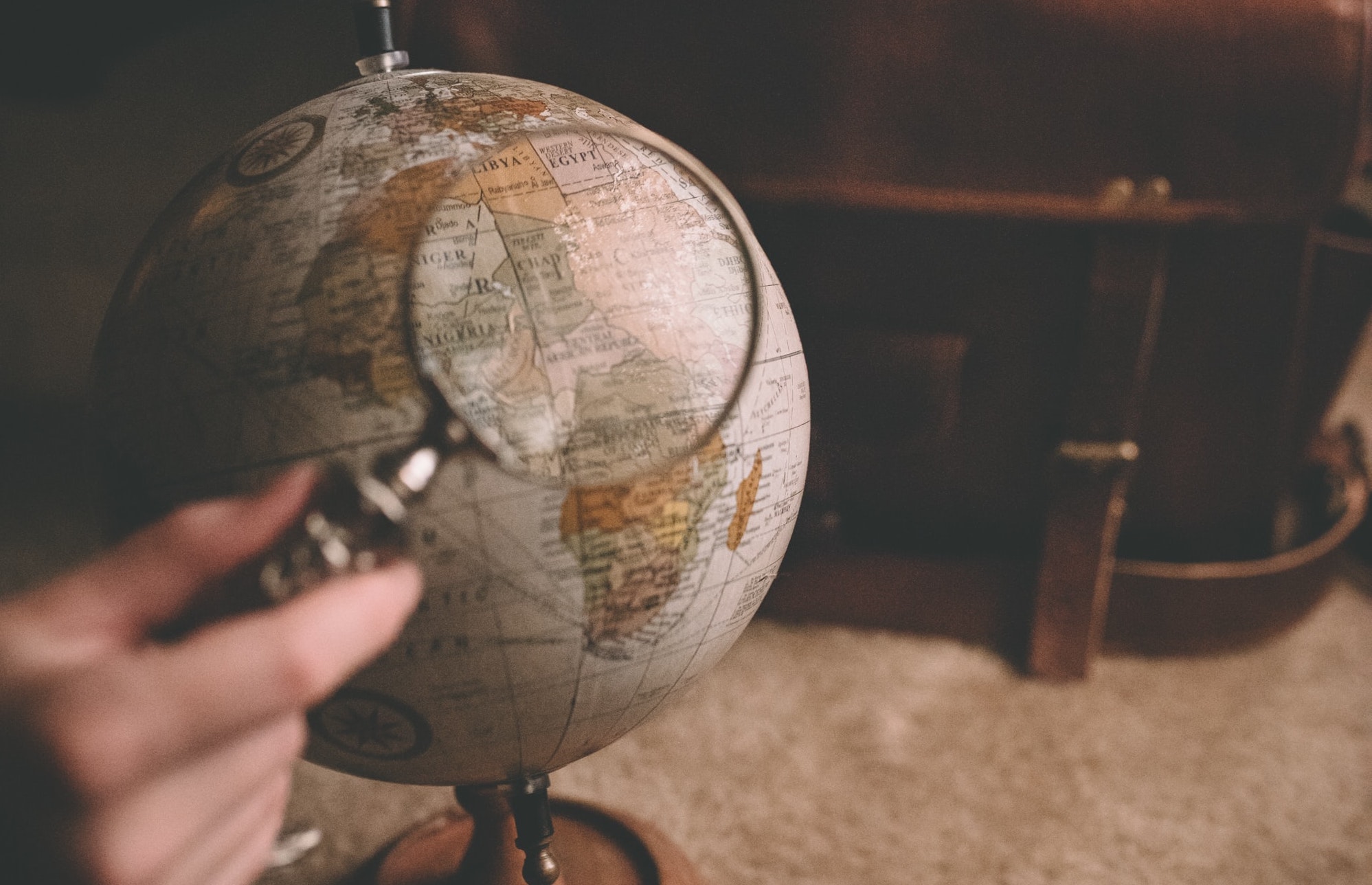 Globe and magnifying glass. Photo by Clay Banks on Unsplash.